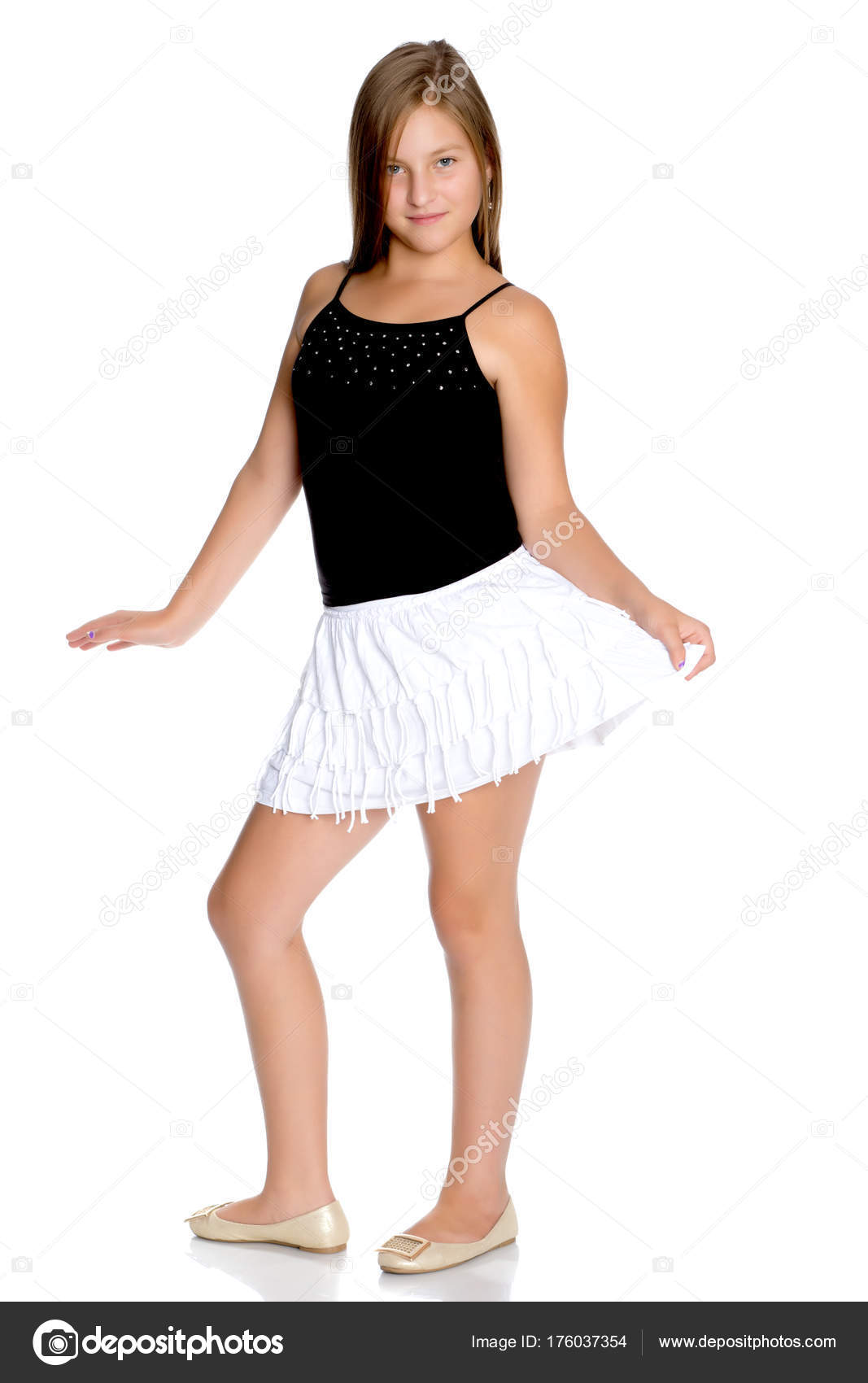 A teenage girl in a short white skirt and a black T shirt. Stock