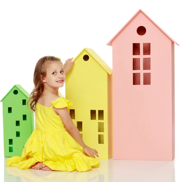 Menina está brincando com casas de madeira . — Fotografia de Stock