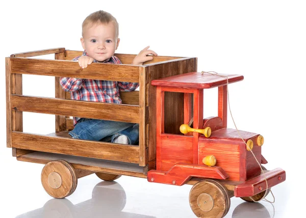 A little boy is playing with a toy car. — Stock Photo, Image