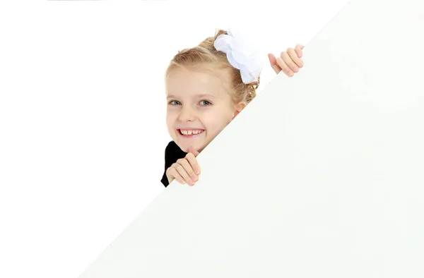 Το κορίτσι που κρυφοκοιτάζει από πίσω από το λευκό πανό. — Φωτογραφία Αρχείου