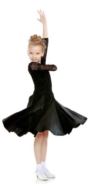 Beautiful little dancer in a black dress. — Stock Photo, Image