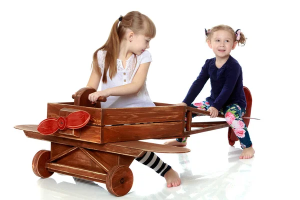 Due sorelle che giocano in un piano di legno — Foto Stock