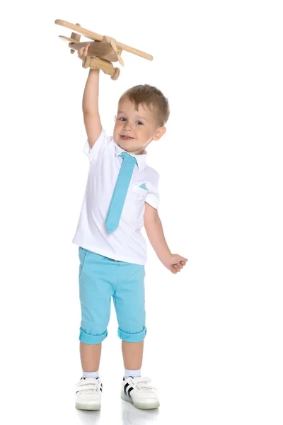 Little boy playing with wooden plane — Stock Photo, Image