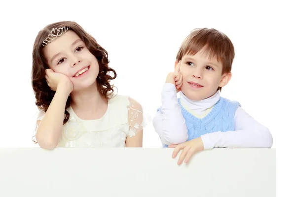 Children look out from behind the banner. — Stock Photo, Image