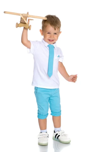 Little boy playing with wooden plane — Stock Photo, Image