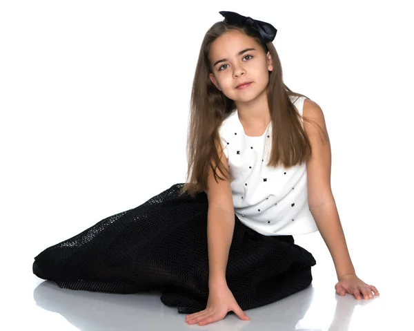 stock image A teenage girl is sitting on the floor.