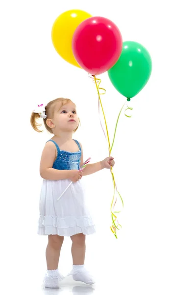 Little girl is playing with a balloon — Stock Photo, Image