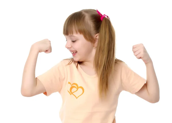 Una niña pequeña muestra sus músculos . — Foto de Stock