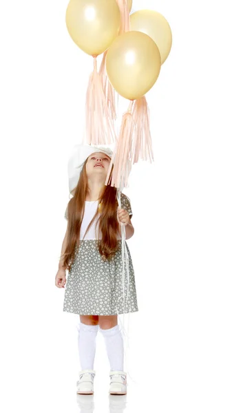 Little girl is playing with a balloon — Stock Photo, Image