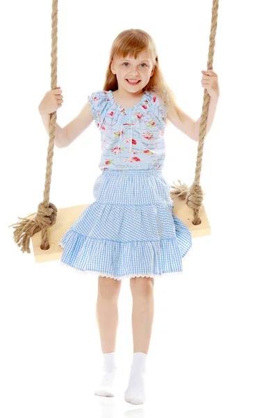 Little girl swinging on a swing — Stock Photo, Image