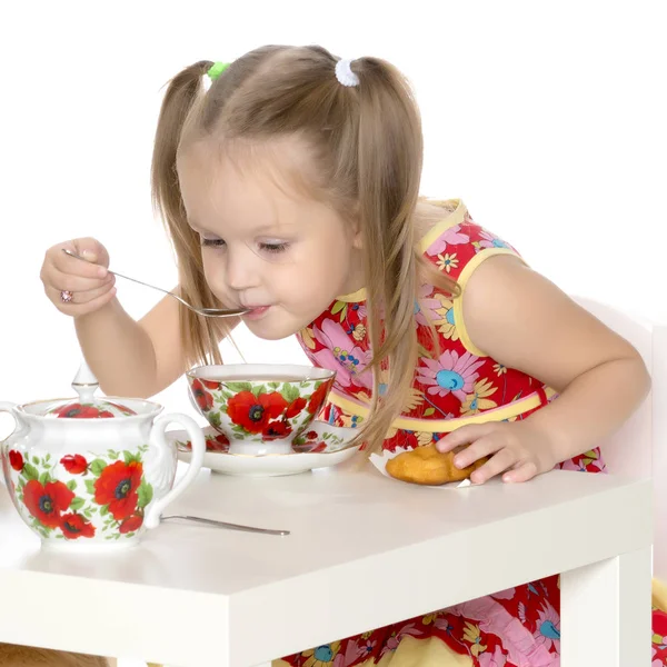 Little girl is drinking tea — Stock Photo, Image