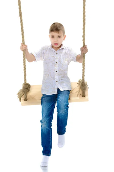 Little boy swinging on a swing — Stock Photo, Image