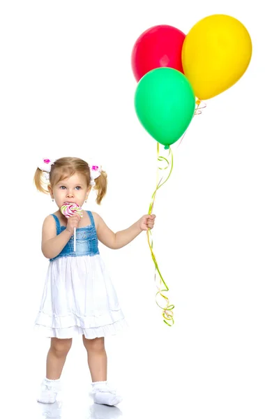 Little girl is playing with a balloon — Stock Photo, Image