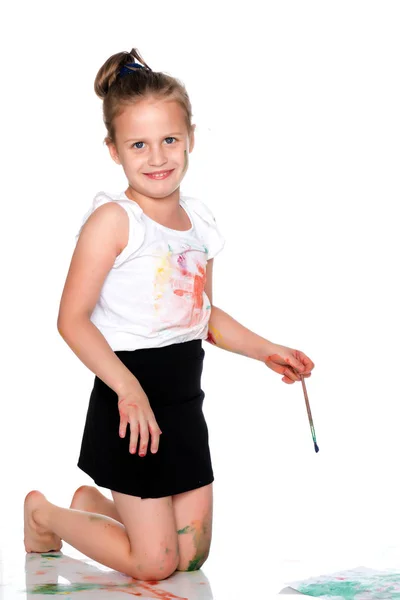 Ein kleines Mädchen zeichnet Farben auf ihren Körper — Stockfoto