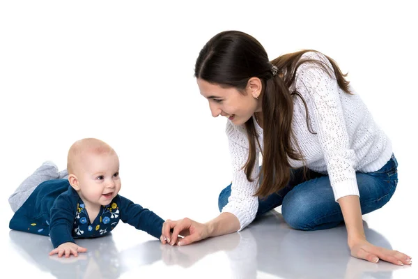 Mom with little daughter on the floor on a white background. — Stock Photo, Image