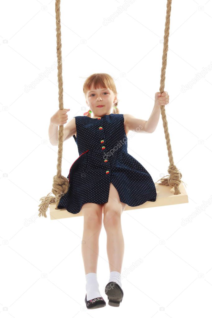 Little girl swinging on a swing