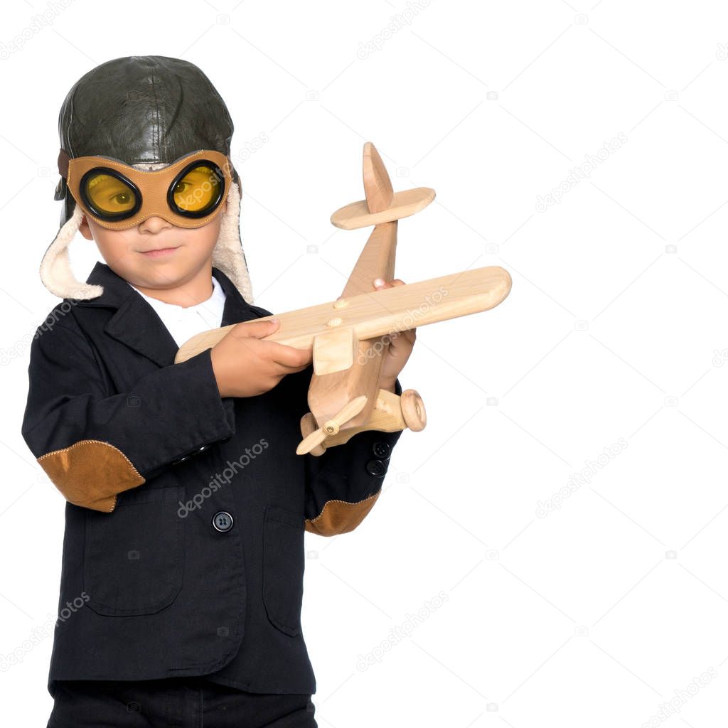 Little boy with a wooden plane.