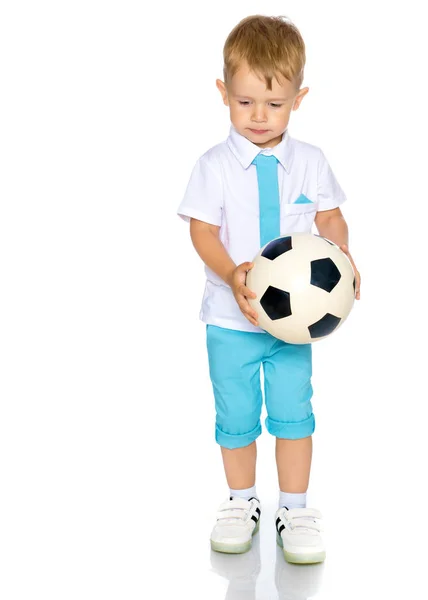 Um menino está brincando com uma bola . — Fotografia de Stock