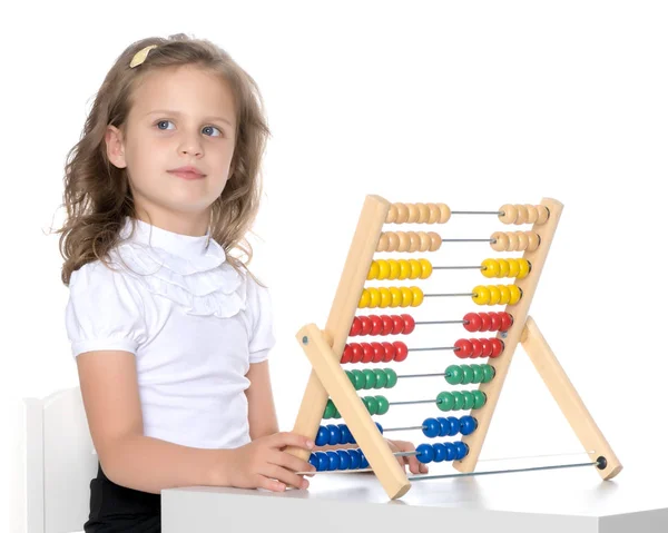 The girl counts on abacus Royalty Free Stock Photos