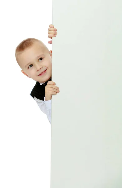 Niño asoma por detrás de la pancarta —  Fotos de Stock