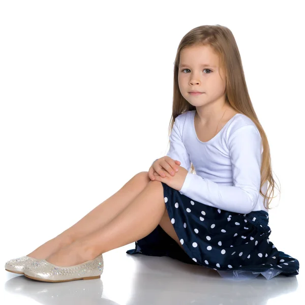 Little girl is sitting on the floor. — Stock Photo, Image