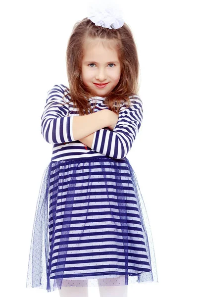 Cute little girl posing in front of the camera. Stock Photo