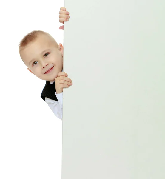 Boy peeks out from behind the banner Stock Photo