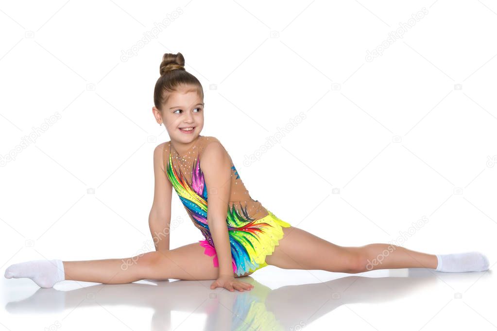 Girl gymnast perform the twine exercise.