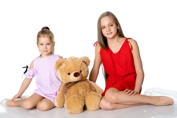 Girls with a teddy bear. — Stock Photo, Image