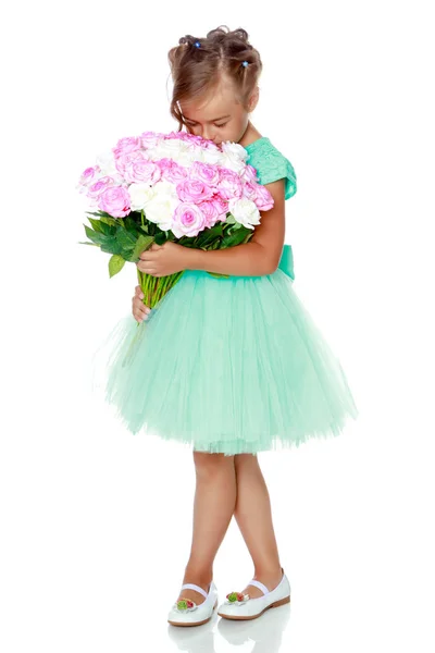 Little girl with a bouquet of flowers — Stock Photo, Image