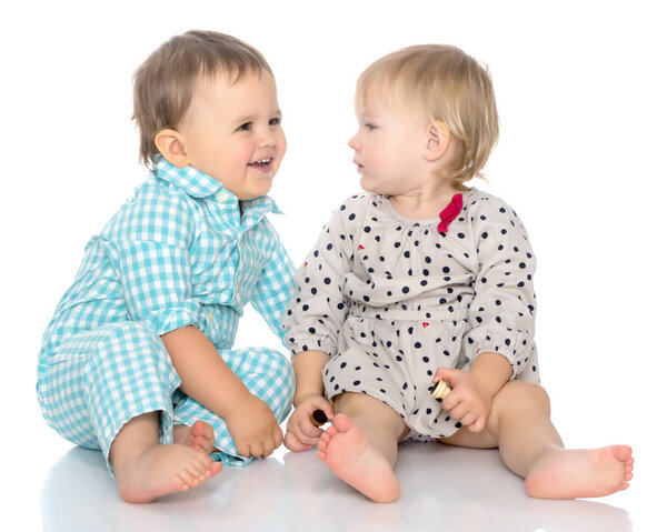 Babies boys and a girl cute embrace.