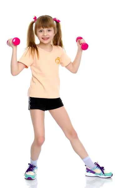 A little girl does gymnastic exercises. — Stock Photo, Image