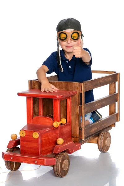 A little boy is playing with a toy car. — Stock Photo, Image