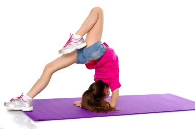 Bir jimnastikçi kollarının önünde egzersiz yapar..