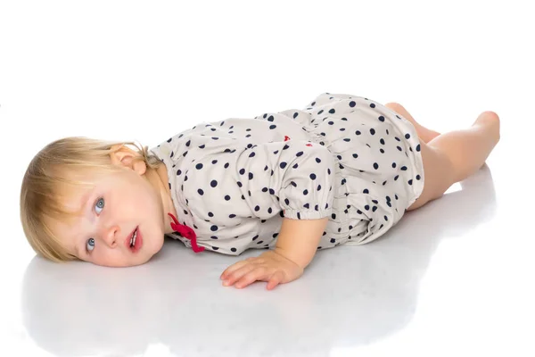 Little girl lies on the floor — Stock Photo, Image