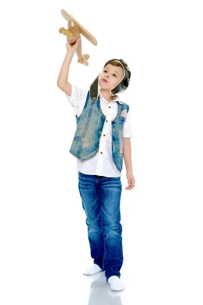 Little boy with a wooden plane. Stock Photo