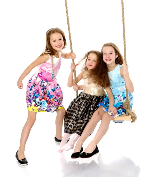 Joyful children swing on a swing. — Stock Photo, Image