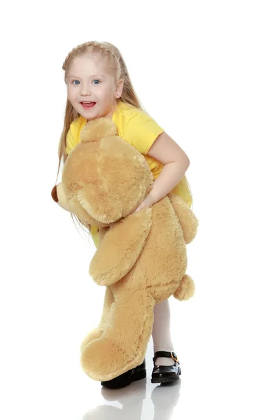 Girl hugs a big teddy bear. — Stock Photo, Image