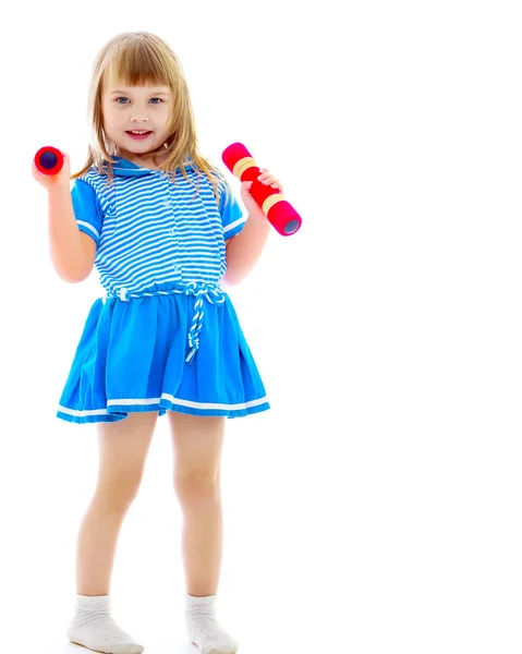 Little girl doing exercises with dumbbells. — Stock Photo, Image