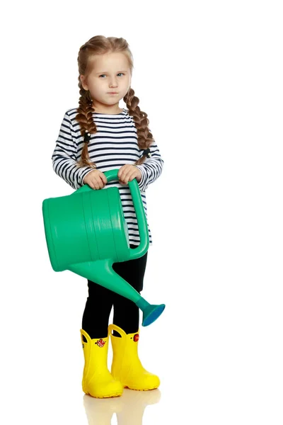 A little girl is watering a garden. — Stock Photo, Image