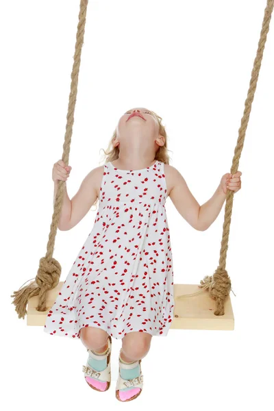 Little girl swinging on a swing — Stock Photo, Image