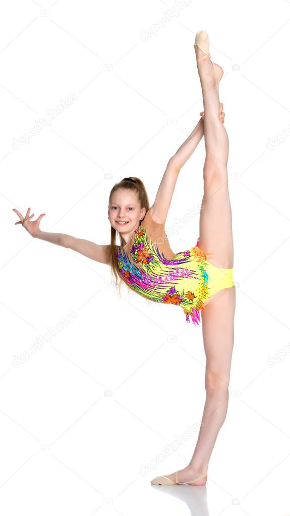 The gymnast balances on one leg.