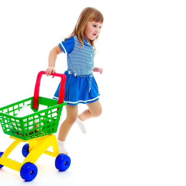 Bambina con un carrello al supermercato . — Foto Stock