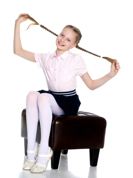 The little girl is pulling herself in pigtails. — Stock Photo, Image