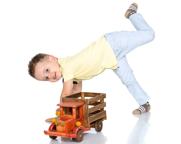 Un niño pequeño está jugando con un coche de juguete. — Foto de Stock
