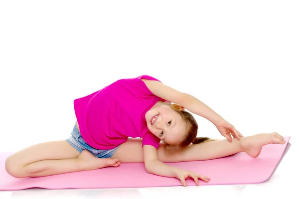 Gimnastyczka wykonuje akrobatyczny element na podłodze. — Zdjęcie stockowe