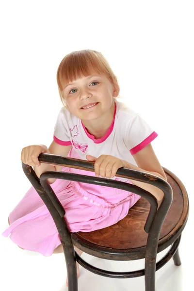 Little girl is sitting on a chair — Stock Photo, Image