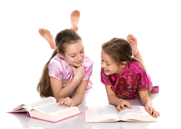Sister girls read a book. — Stock Photo, Image