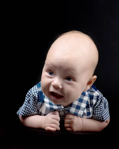 Een charmante baby kijkt naar de camera. — Stockfoto