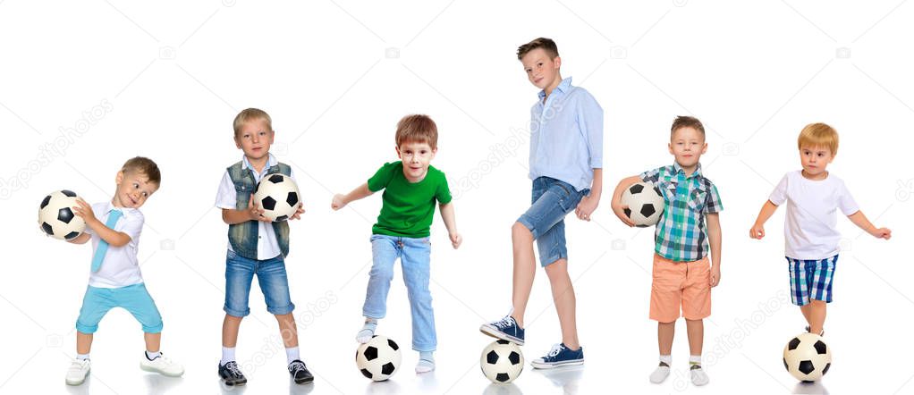 A large group of boys with soccer balls.